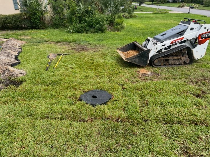 A crew excavating a residential yard for an underground propane tank installation